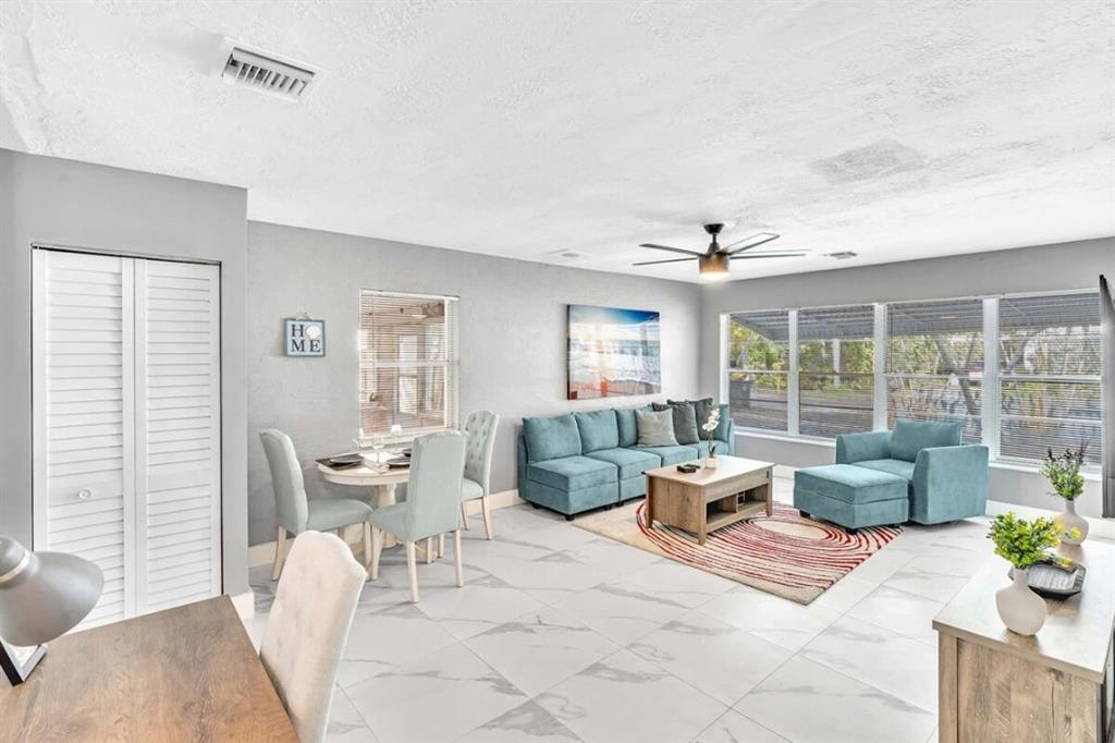 253 Southwest 7th Street, Unit A Dania Beach, FL 33004 - Photo 17 of 22 a living room with furniture and large windows