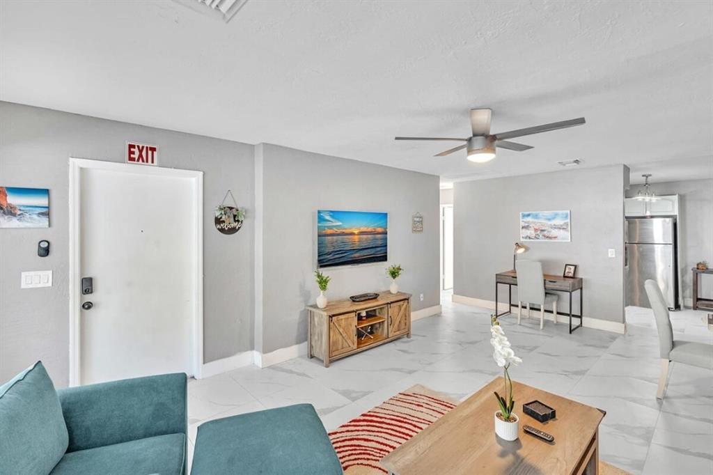 253 Southwest 7th Street, Unit A Dania Beach, FL 33004 - Photo 18 of 22 a living room with furniture and a flat screen tv
