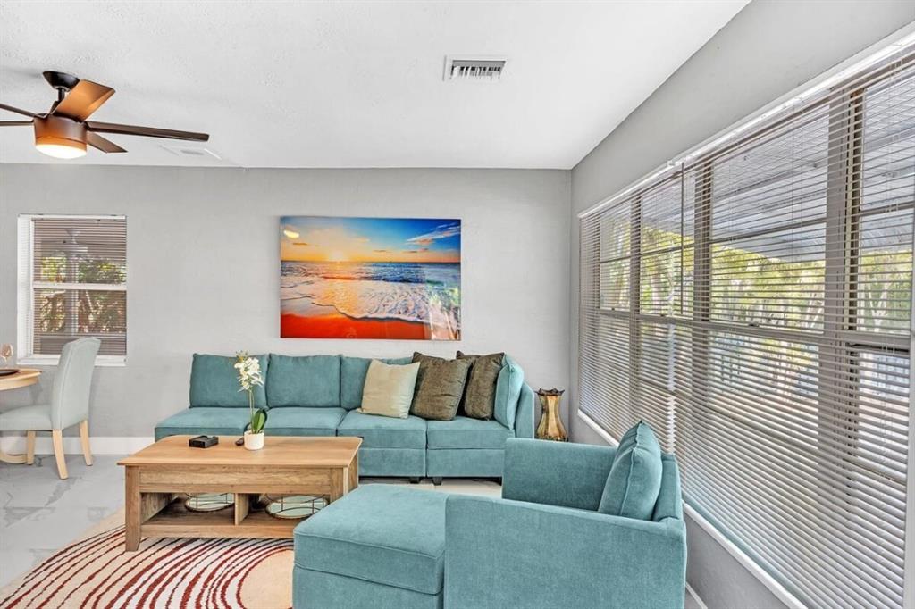 253 Southwest 7th Street, Unit A Dania Beach, FL 33004 - Photo 2 of 22 a living room with furniture and a large window