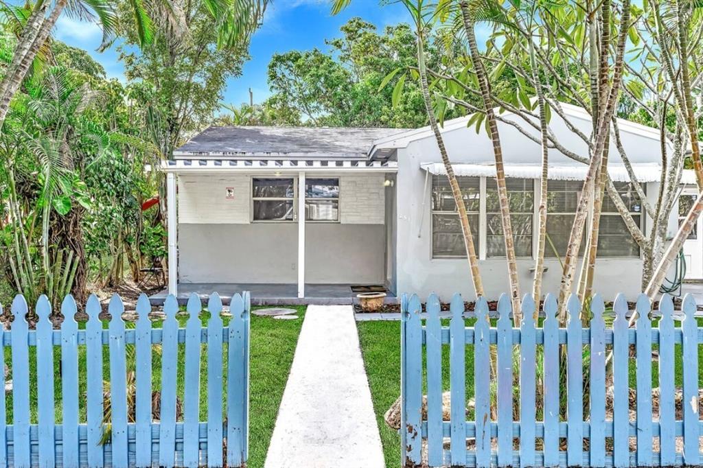 253 Southwest 7th Street, Unit A Dania Beach, FL 33004 - Photo 6 of 22 a front view of a house with a garden