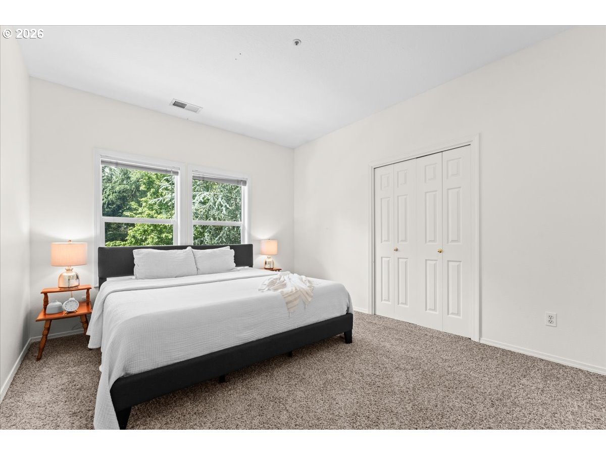 12431 Southwest 55th Place Portland, OR 97219 - Photo 17 of 40 a bedroom with a bed and a window