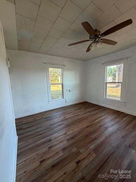 1711 Dickinson Road Hickory, NC 28602 - Photo 3 of 13 an empty room with wooden floor fan and windows