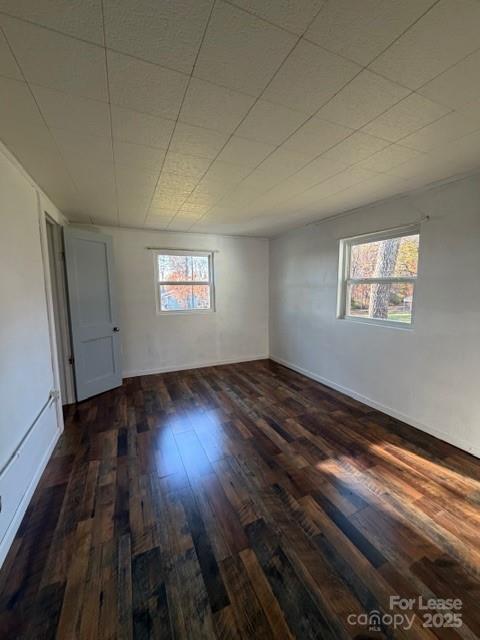 1711 Dickinson Road Hickory, NC 28602 - Photo 10 of 13 an empty room with wooden floor and windows