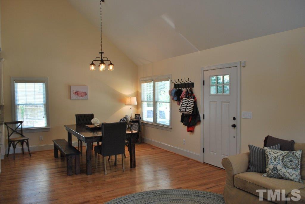 918 Dixie Trail Raleigh, NC 27607 - Photo 14 of 23 a dining room with furniture a chandelier and wooden floor