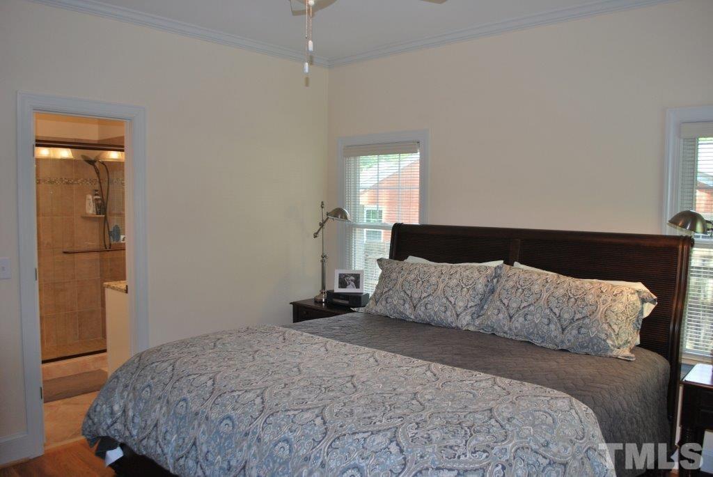 918 Dixie Trail Raleigh, NC 27607 - Photo 16 of 23 a bedroom with a bed and wooden floor