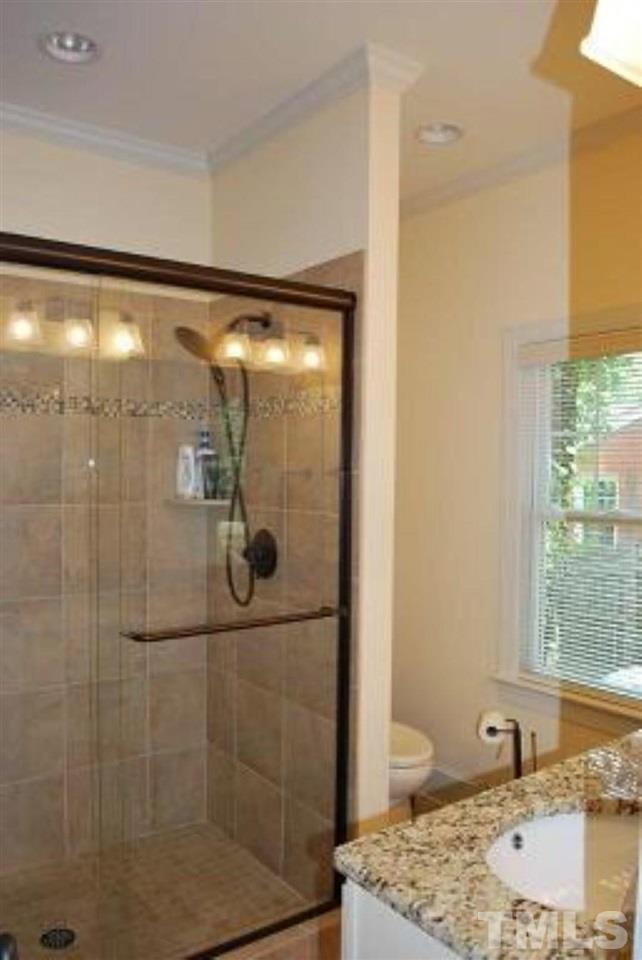 918 Dixie Trail Raleigh, NC 27607 - Photo 17 of 23 a bathroom with a granite countertop shower a sink and toilet