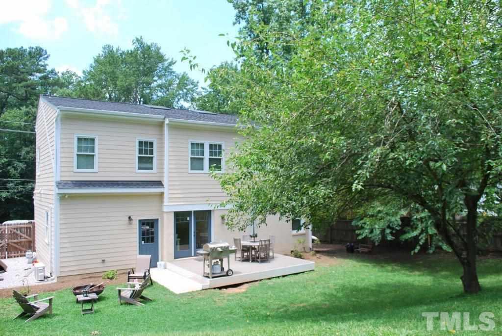 918 Dixie Trail Raleigh, NC 27607 - Photo 21 of 23 a view of a backyard with table and chairs and a large tree