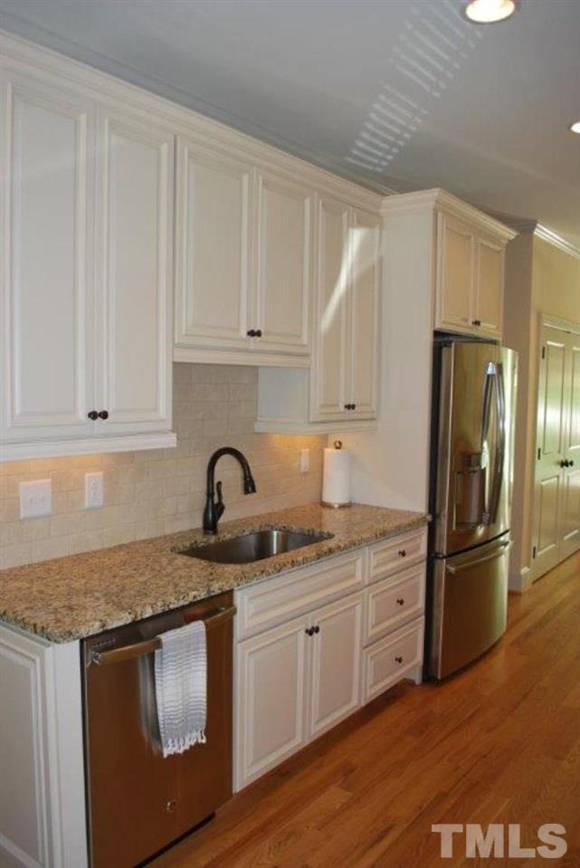 918 Dixie Trail Raleigh, NC 27607 - Photo 9 of 23 a kitchen with stainless steel appliances granite countertop a refrigerator sink and cabinets