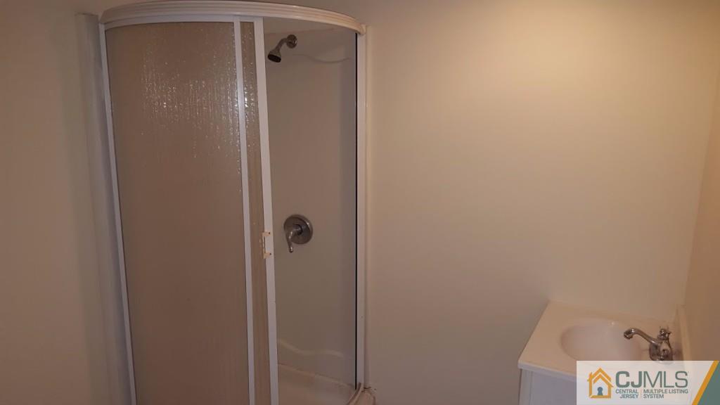 4 Wilcox Road New Brunswick, NJ 08901 - Photo 12 of 14 a bathroom with a shower and a door
