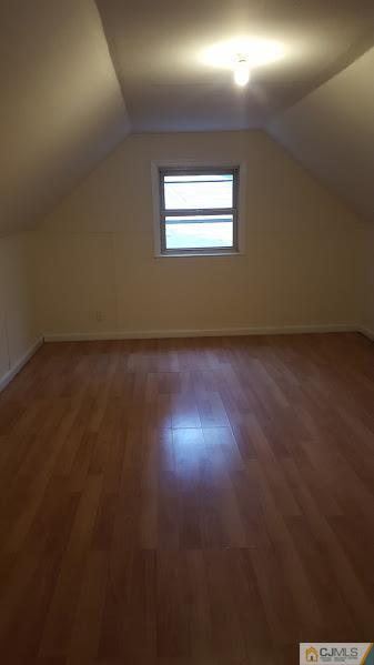 4 Wilcox Road New Brunswick, NJ 08901 - Photo 13 of 14 an empty room with wooden floor and windows