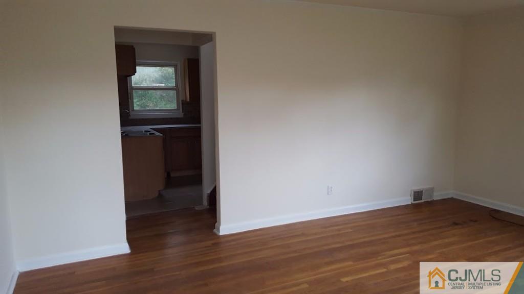 4 Wilcox Road New Brunswick, NJ 08901 - Photo 3 of 14 a view of an empty room and wooden floor