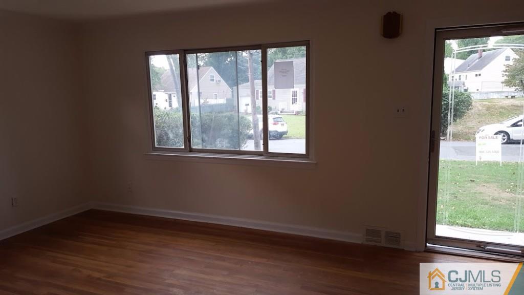 4 Wilcox Road New Brunswick, NJ 08901 - Photo 4 of 14 a view of an empty room with wooden floor and a window