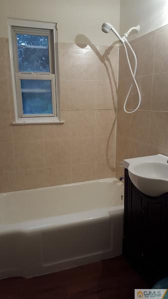 4 Wilcox Road New Brunswick, NJ 08901 - Photo 6 of 14 a bathroom with a bathtub and a shower