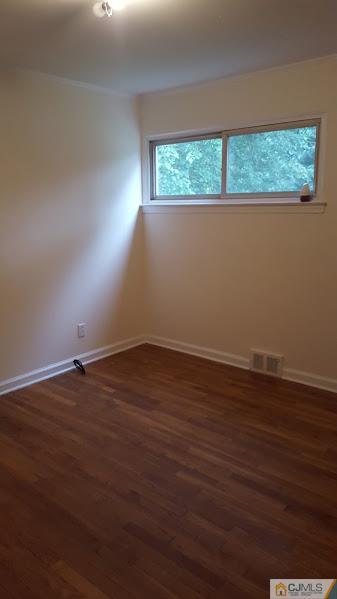 4 Wilcox Road New Brunswick, NJ 08901 - Photo 8 of 14 an empty room with wooden floor and windows