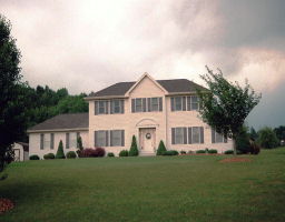 907 Renaldi Road Wind Gap, PA 18091 - Photo 1 of 1 a view of a white house with a big yard and large trees
