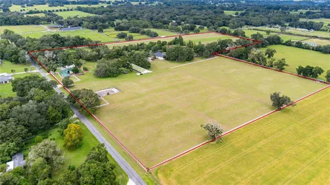 an aerial view of residential houses with outdoor space and river
