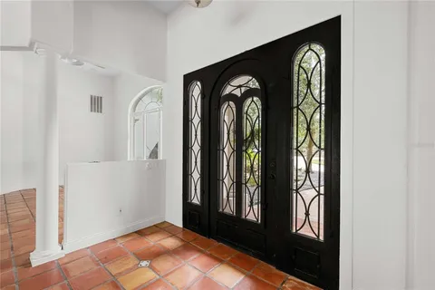 a view of a entryway door with wooden floor