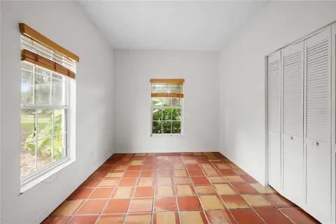 an aerial view of a house with swimming pool and patio