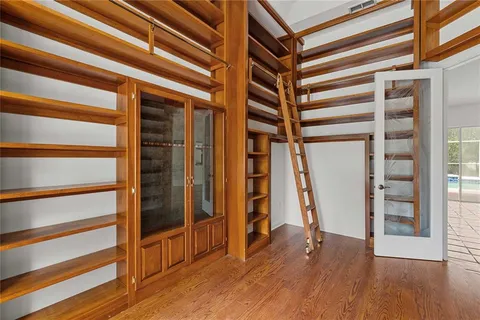 a view of a room with wooden floor and stairs