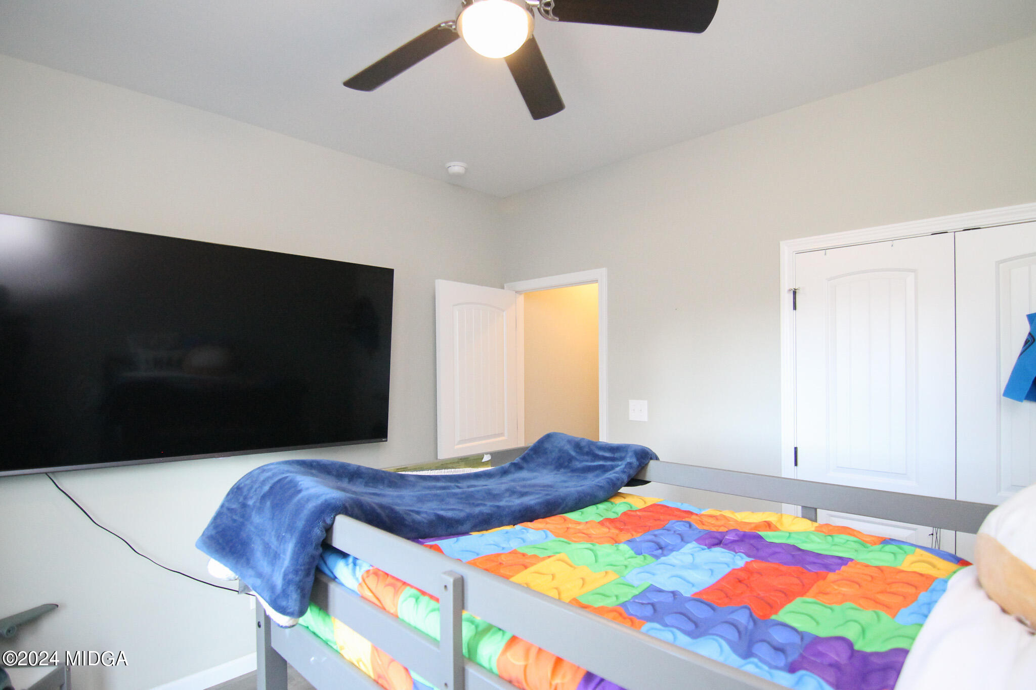 144 Summit Drive Byron, GA 31008 - Photo 22 of 27 a bedroom with a bed and a flat screen tv
