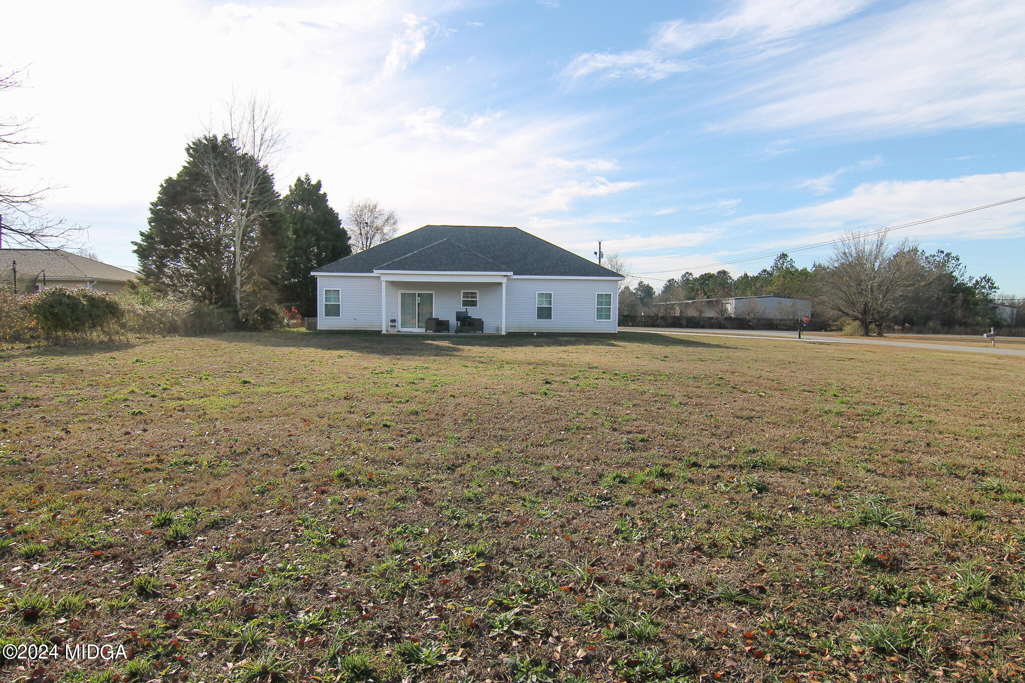 144 Summit Drive Byron, GA 31008 - Photo 25 of 27 a large house with a big yard and large trees