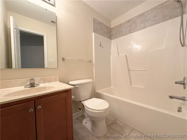 an empty room with windows and ceiling fan