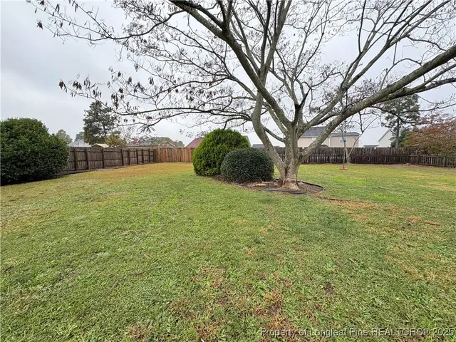 a view of a house with a yard and garage