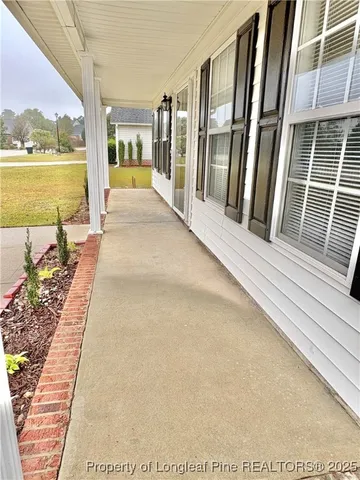 a view of a balcony with lake view and a floor to ceiling window