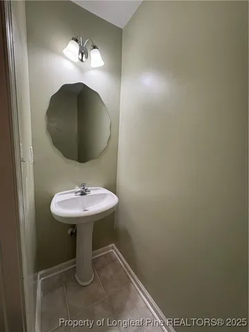 a bathroom with a sink toilet and a mirror