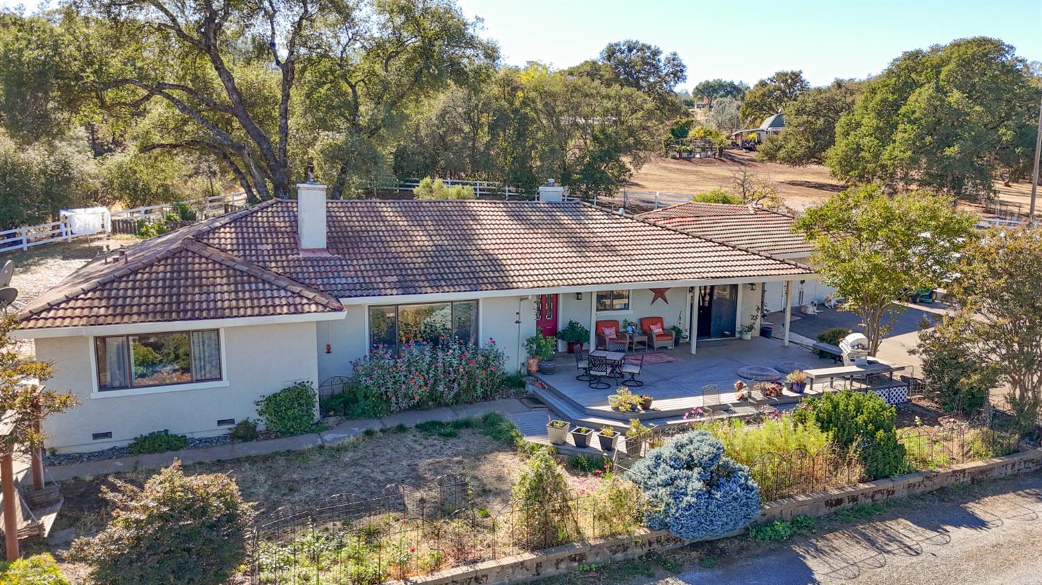 4770 Pedro Hill Road Pilot Hill, CA 95664 - Photo 28 of 87 a view of a patio with table and chairs under an umbrella