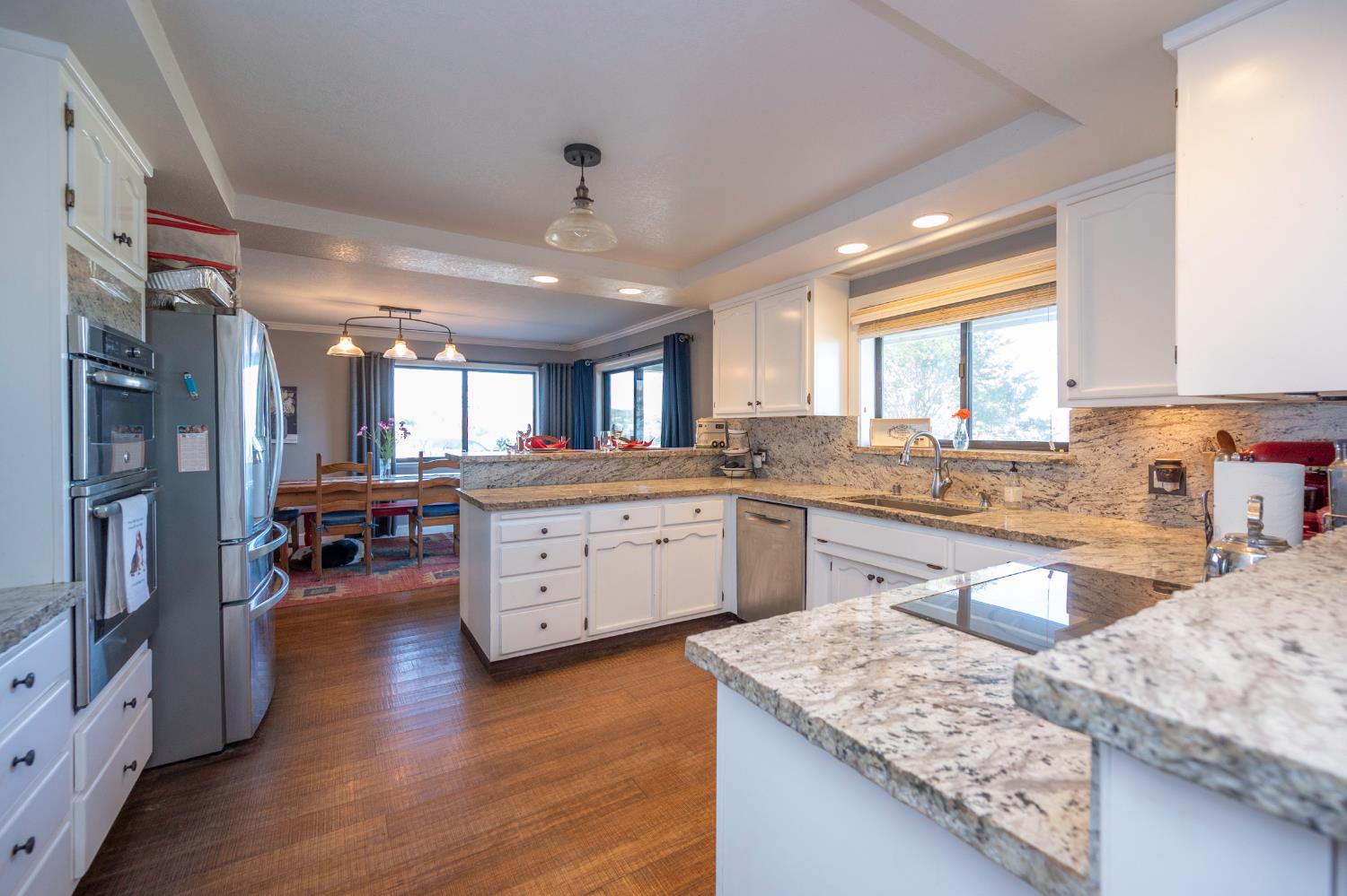 4770 Pedro Hill Road Pilot Hill, CA 95664 - Photo 50 of 87 a large kitchen with stainless steel appliances granite countertop a lot of counter space and wooden floors