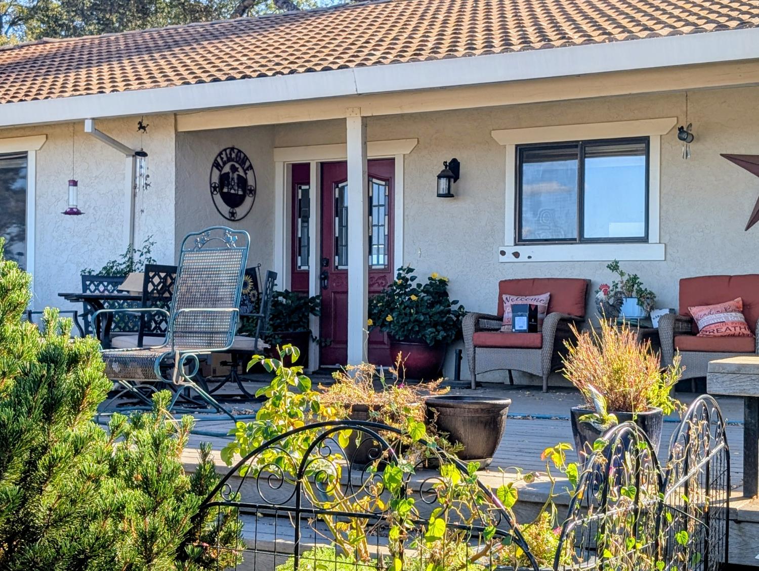 4770 Pedro Hill Road Pilot Hill, CA 95664 - Photo 5 of 87 a front view of house with yard outdoor seating and flowers