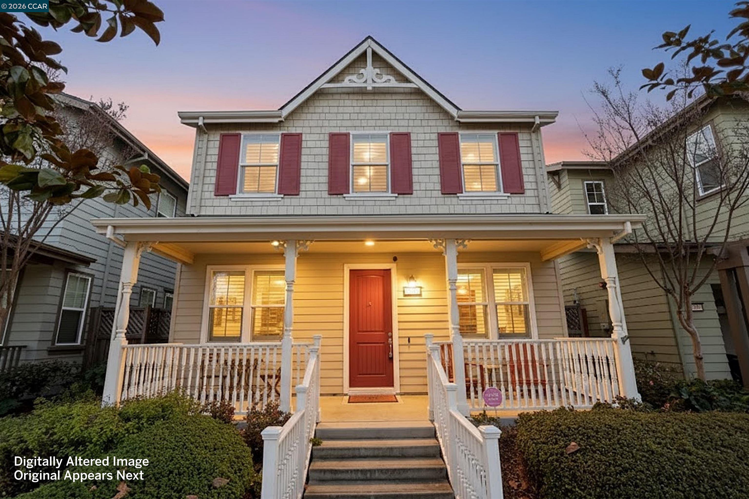 a view of a brick house with large windows and a yard