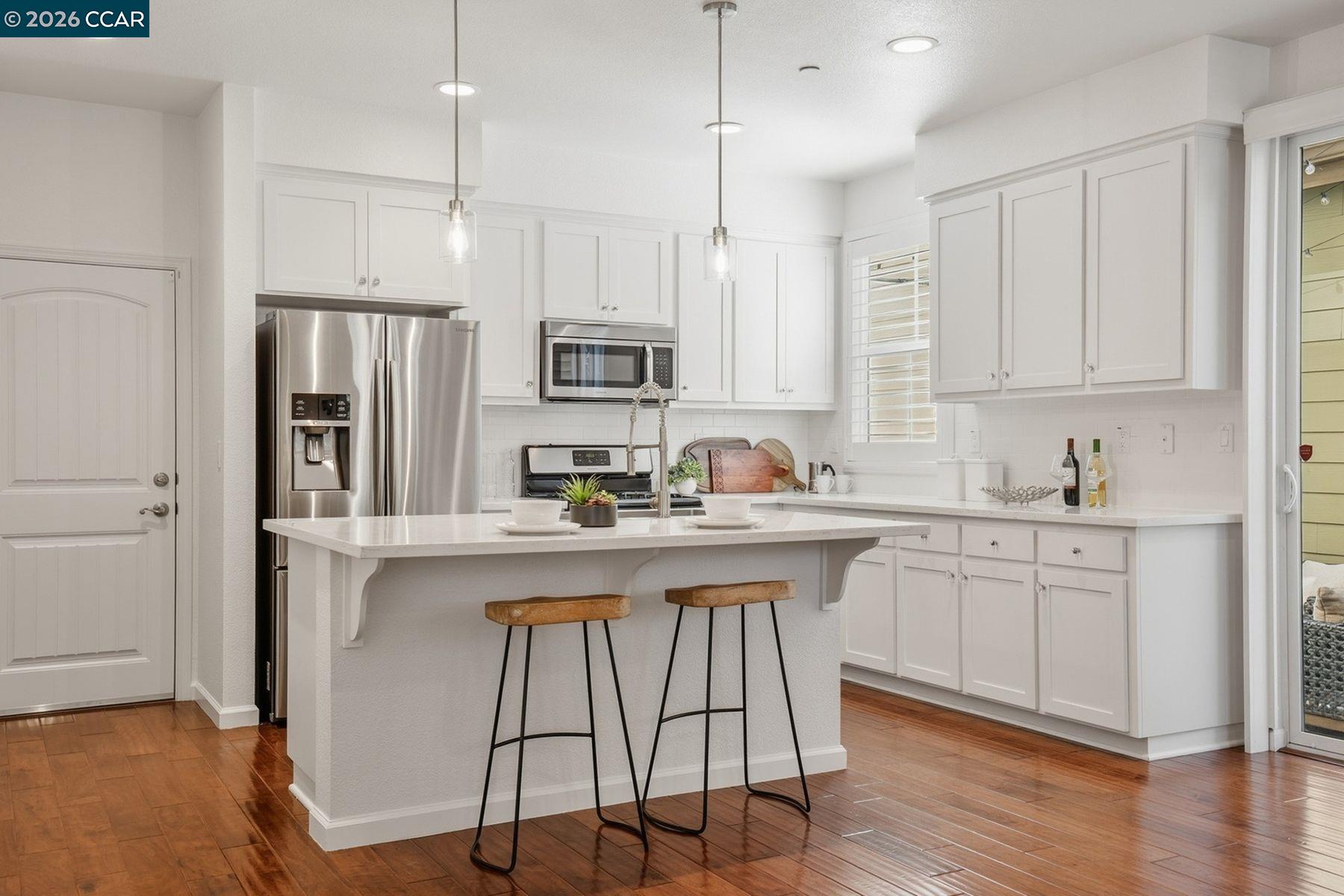 22640 Filbert Street Hayward, CA 94541 - Photo 14 of 60 a kitchen with stainless steel appliances granite countertop a sink a stove a refrigerator and island with wooden floor