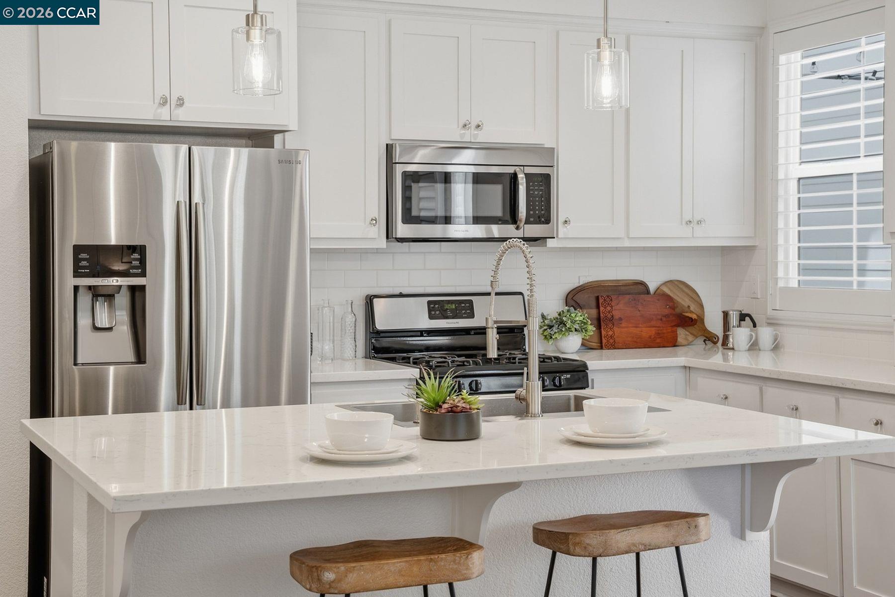 22640 Filbert Street Hayward, CA 94541 - Photo 16 of 60 a kitchen with stainless steel appliances a sink a microwave a refrigerator and cabinets