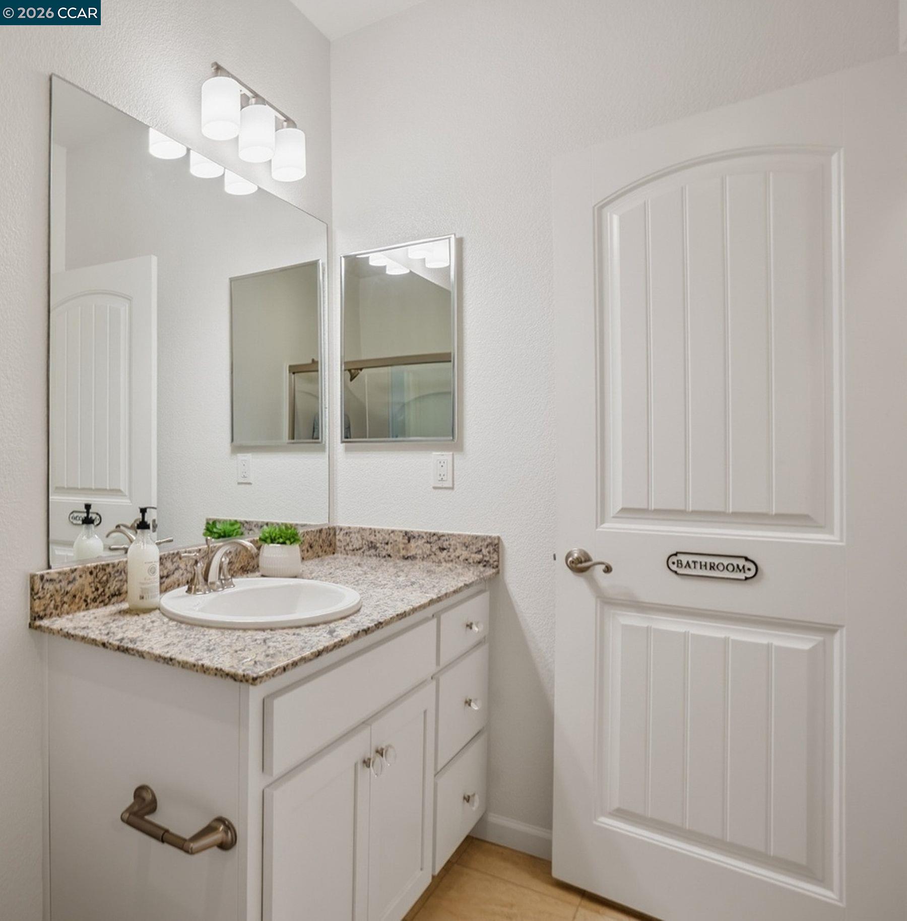 22640 Filbert Street Hayward, CA 94541 - Photo 25 of 60 a bathroom with a sink vanity and a mirror