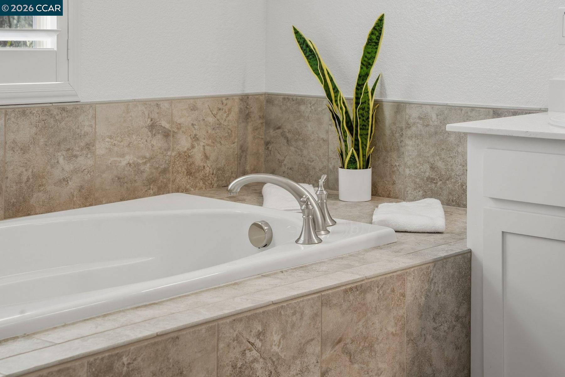 22640 Filbert Street Hayward, CA 94541 - Photo 39 of 60 a bathroom with a sink a mirror and a bathtub