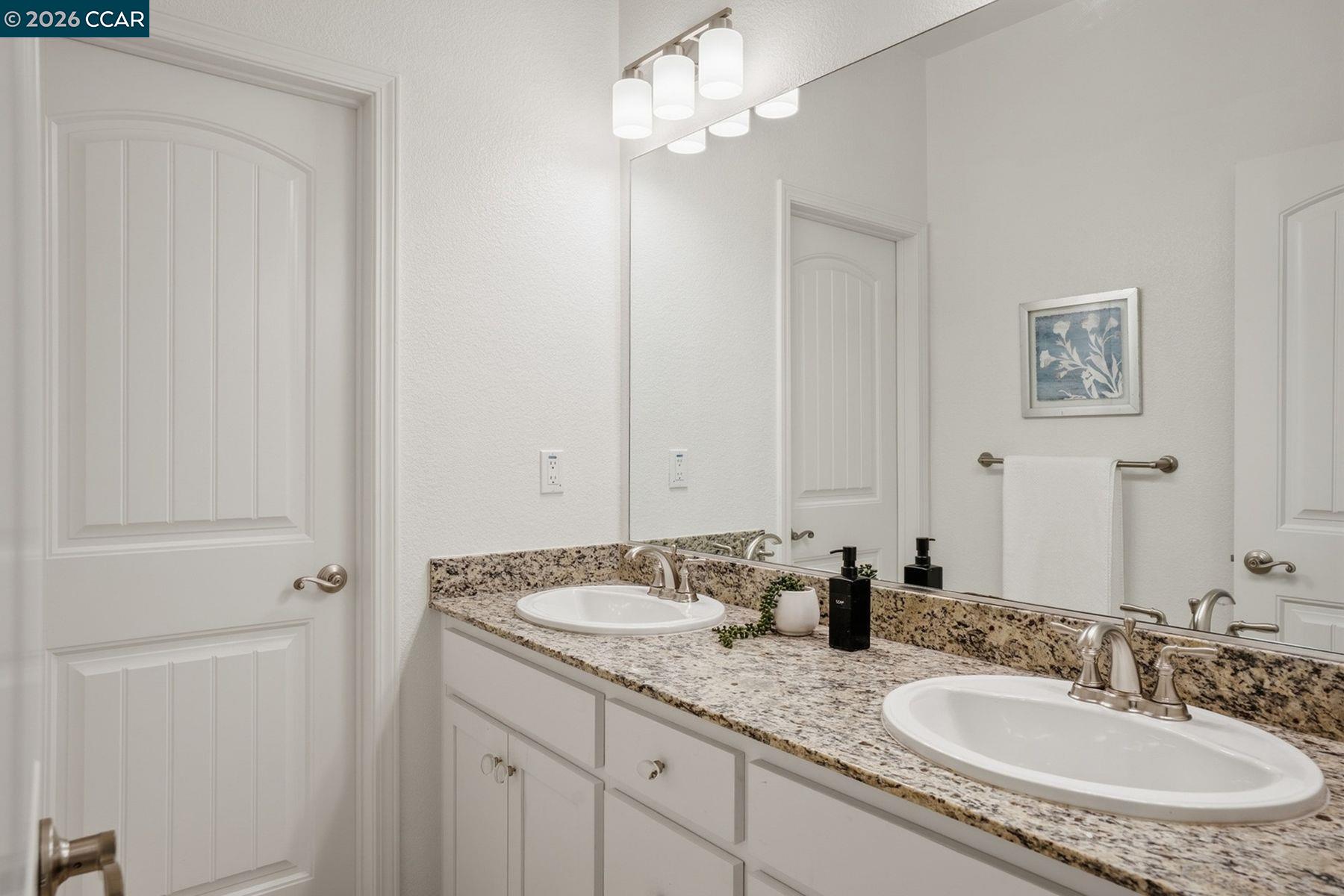 22640 Filbert Street Hayward, CA 94541 - Photo 52 of 60 a bathroom with a granite countertop sink and a mirror
