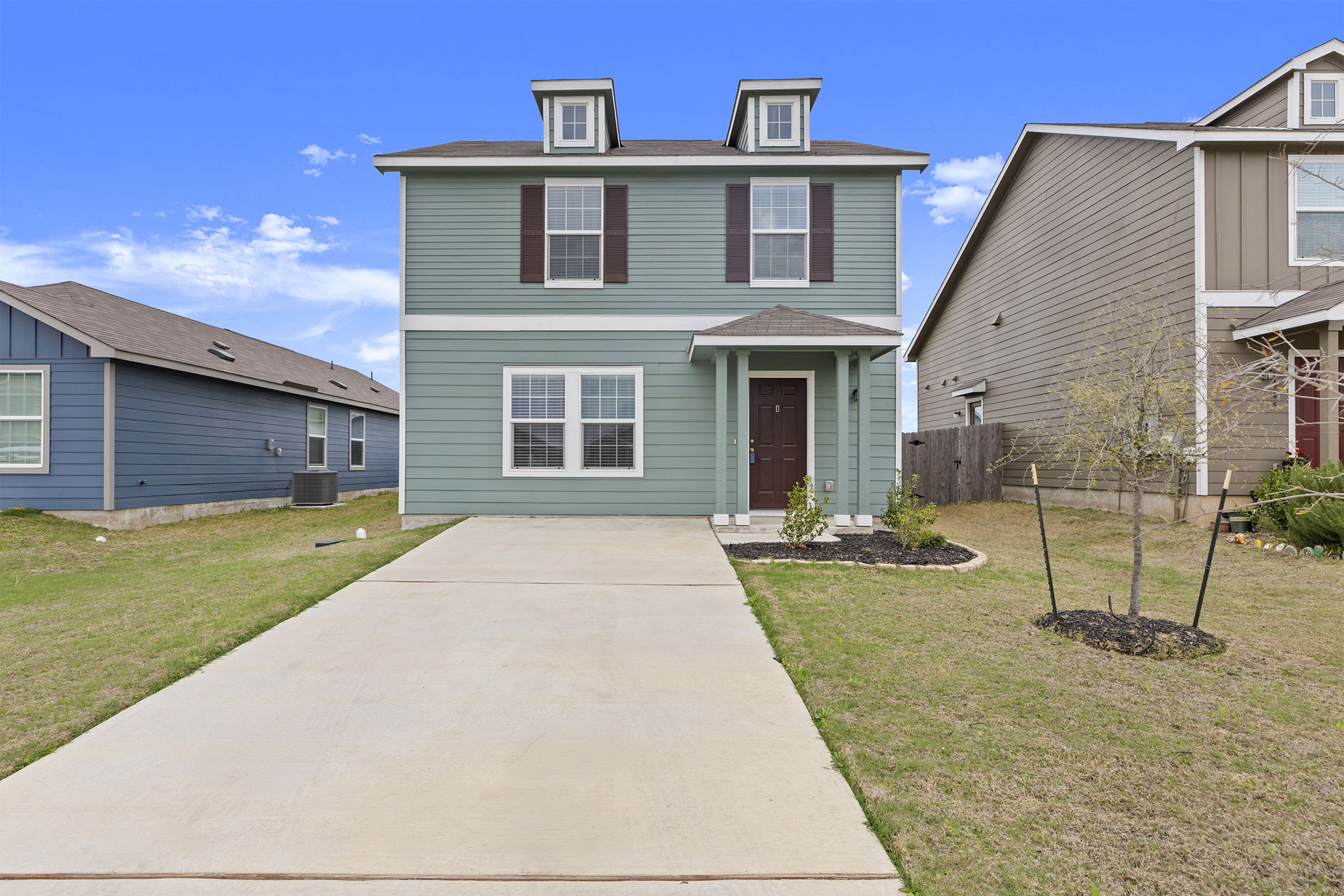 141 Texas Angel Way Jarrell, TX 76537 - Photo 2 of 33 a front view of a house with garden