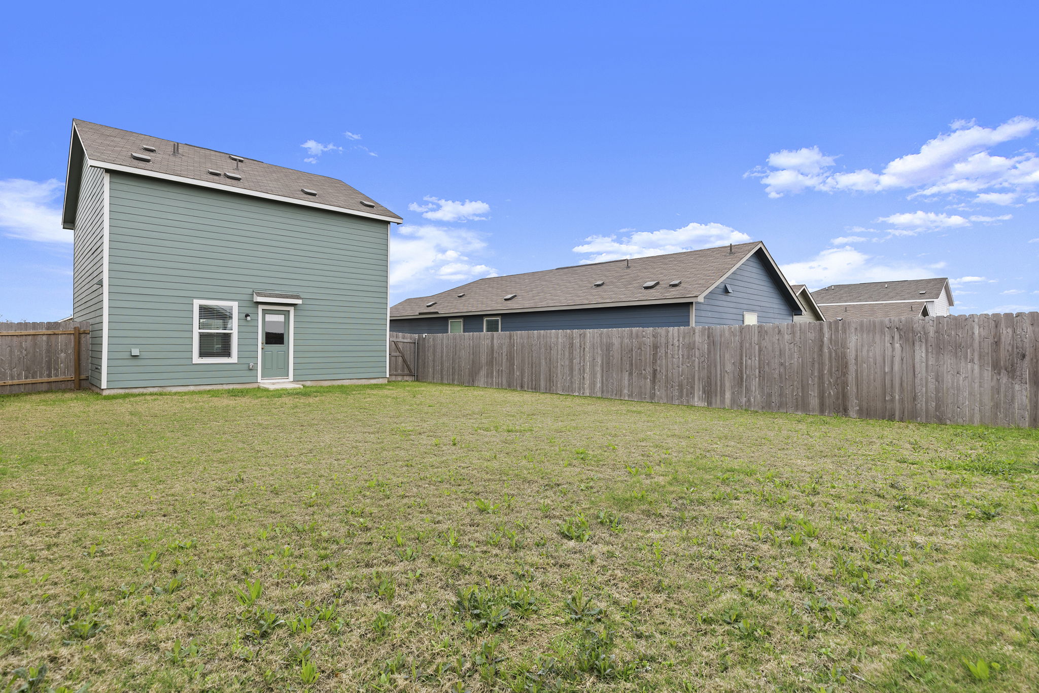 141 Texas Angel Way Jarrell, TX 76537 - Photo 29 of 33 a view of a backyard with wooden fence