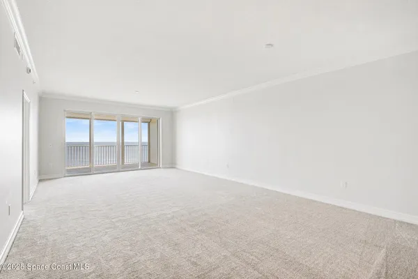 a view of a livingroom with wooden floor and a window