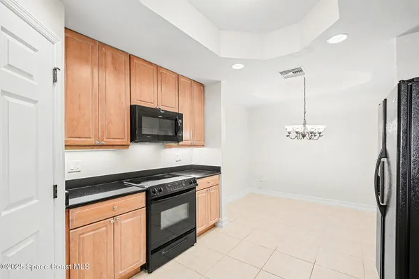 a view of a kitchen with a sink and stainless steel appliances