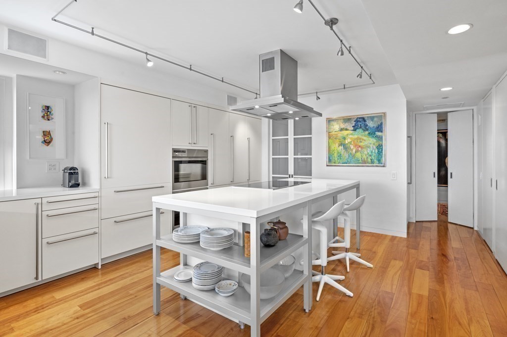 975 Memorial Drive, Unit 906 Cambridge, MA 02138 - Photo 11 of 37 a kitchen with a stove and a wooden floor