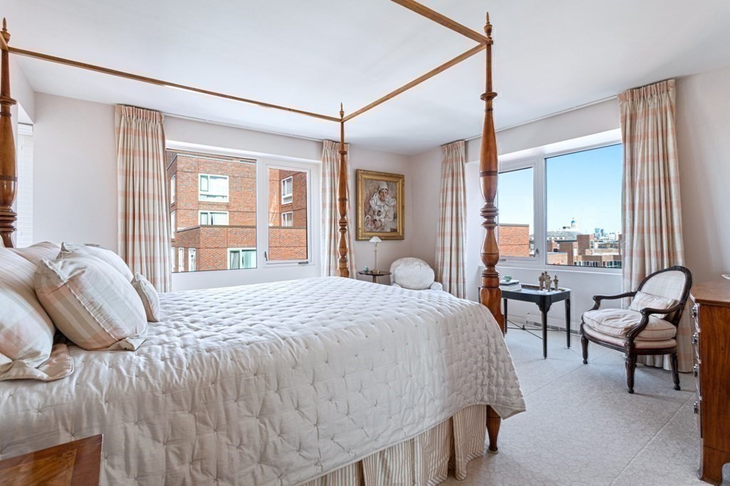 975 Memorial Drive, Unit 906 Cambridge, MA 02138 - Photo 15 of 37 a bedroom with a bed and a mirror