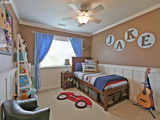 4920 Northwest 146th Place Portland, OR 97229 - Photo 12 of 16 a bedroom with a bed and a chandelier