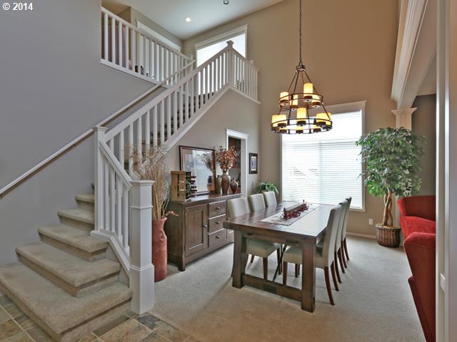 4920 Northwest 146th Place Portland, OR 97229 - Photo 3 of 16 a dining room with furniture a chandelier and wooden floor
