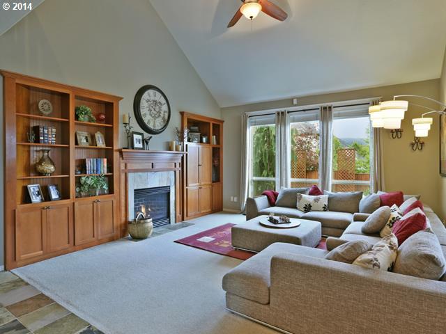 4920 Northwest 146th Place Portland, OR 97229 - Photo 7 of 16 a living room with fireplace furniture and a large window