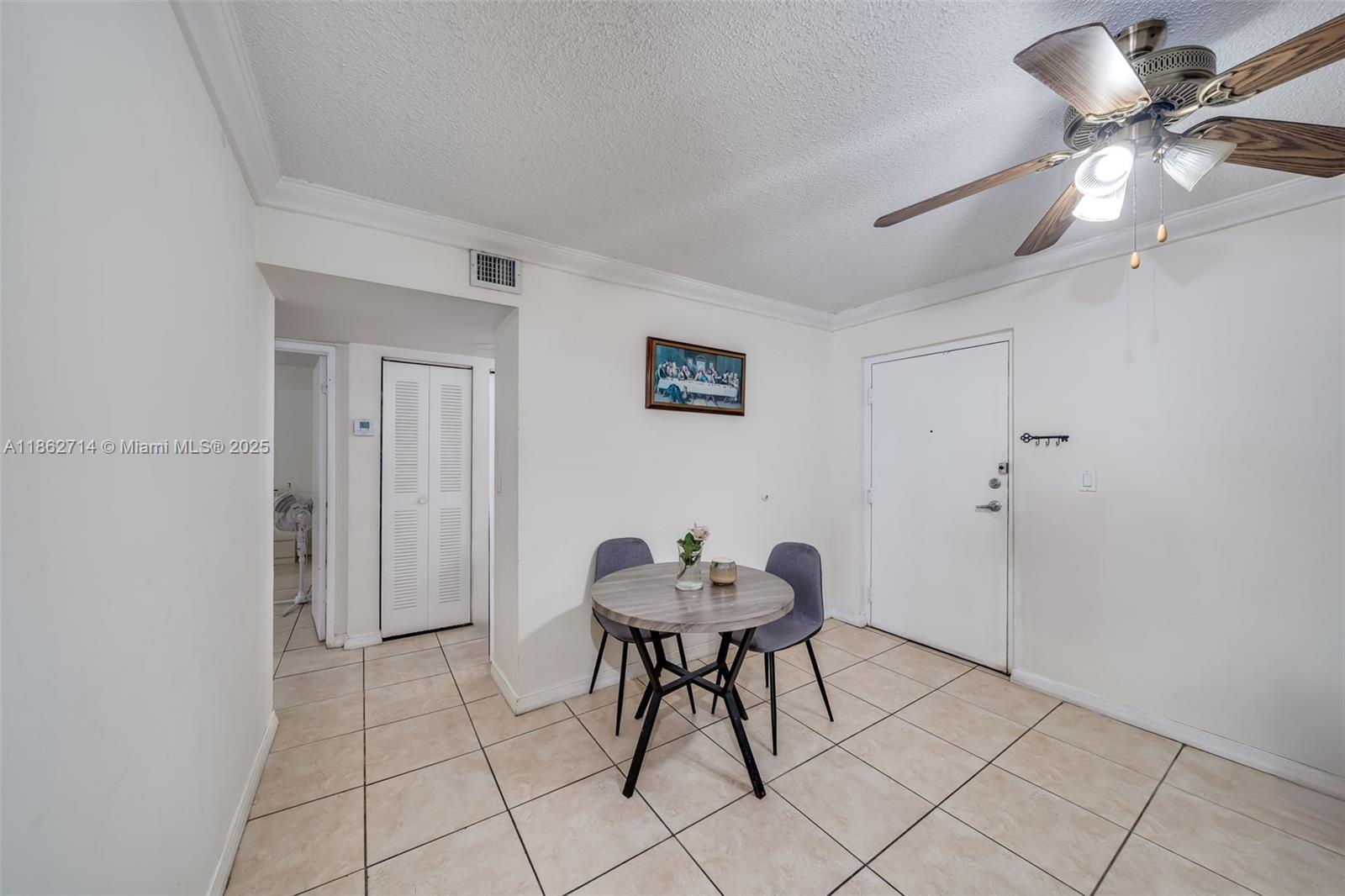 1221 Southwest 122nd Avenue, Unit 215 Miami, FL 33184 - Photo 15 of 57 a workspace room with furniture and fan