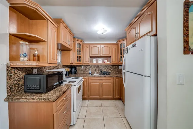 a view of kitchen with stove top oven and cabinets