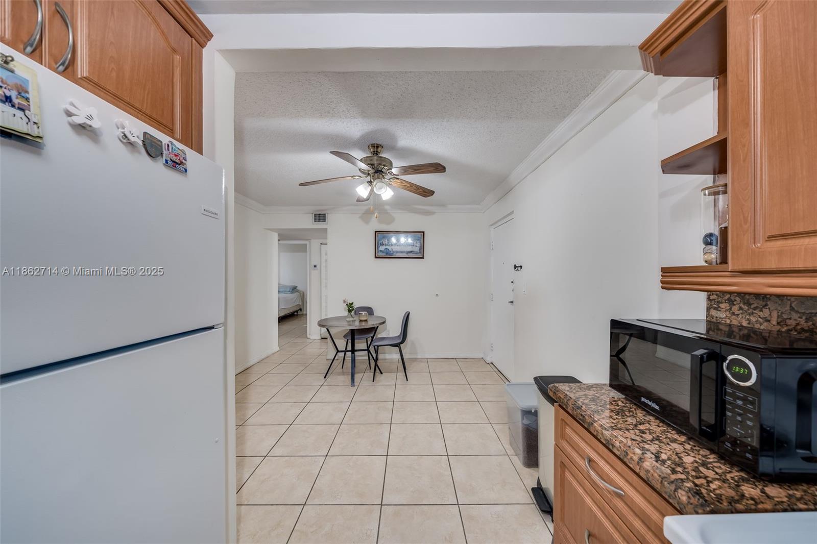 1221 Southwest 122nd Avenue, Unit 215 Miami, FL 33184 - Photo 20 of 57 a view of kitchen with stove top oven and cabinets
